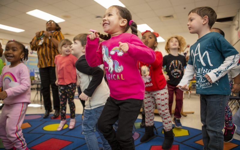 children moving and jumping in the classroom